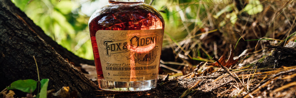 hiking trails, best hiking trails, best hikes in the US,  Fox and Oden whiskey bottle on a dirt path
